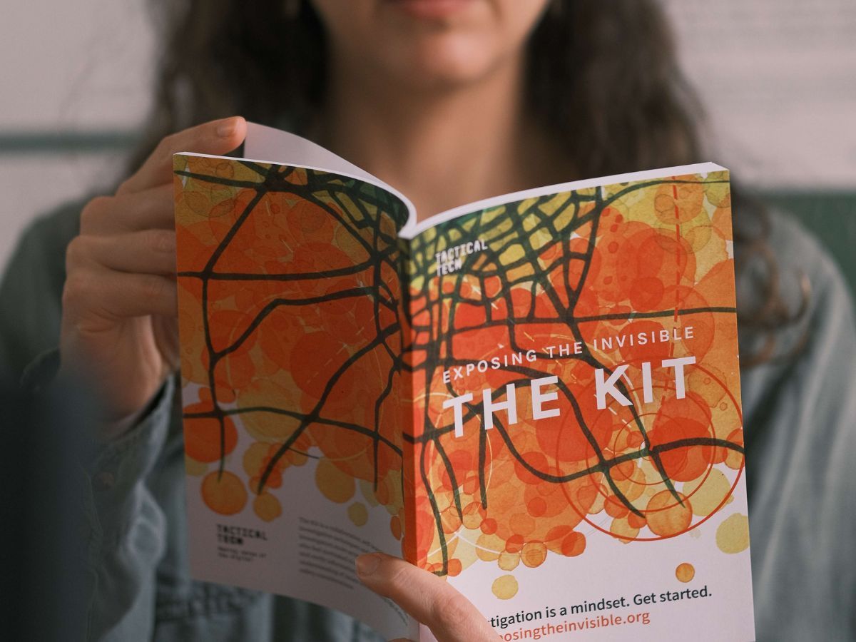 Person reading the Exposing the Invisible-The Kit. Photo courtesy of Eskandar, 2023.