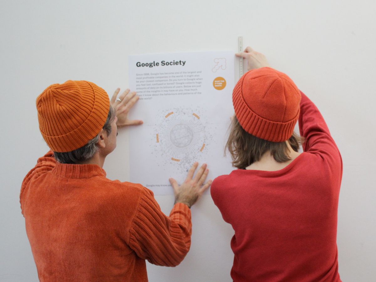 Picture of two people working on a poster